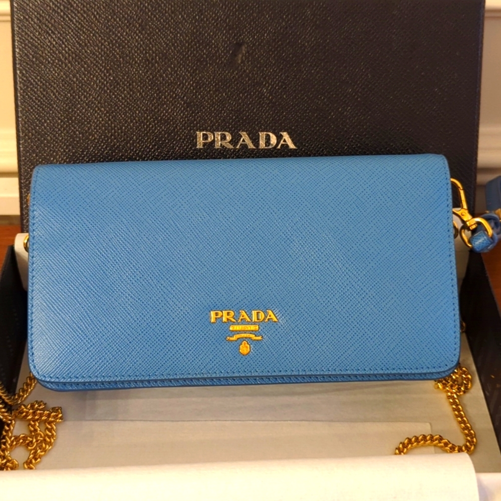PRADA blue leather crossbody bag with gold chain.